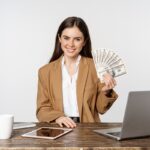 Beginner making first $100 online using laptop with digital income dashboard and online earning methods